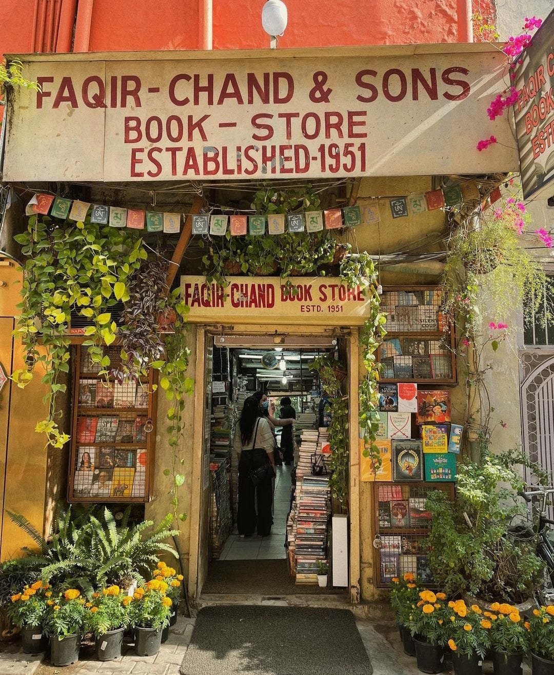 Faqir Chand & Sons storefront with marigolds and trailing plants, Khan Market