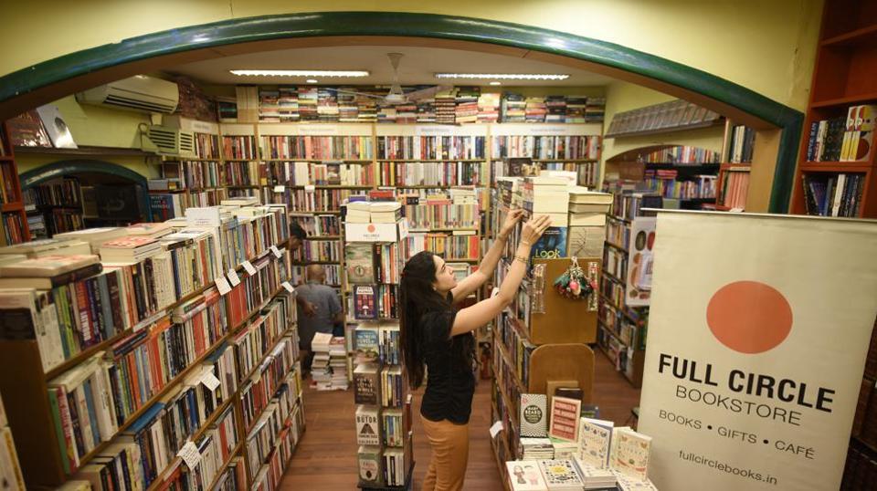 Inside Full Circle Bookstore, shelves packed with books under an archway